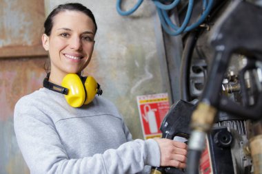 woman unhooking an industrial hose clipart