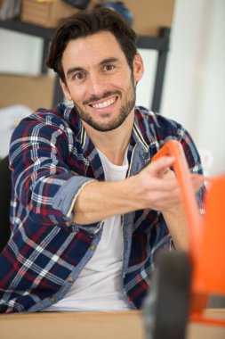 happy male worker smiling at the camera clipart