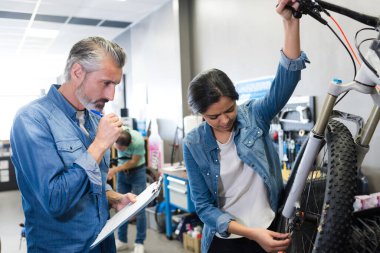 portrait of female apprentice bicycle mechanic clipart