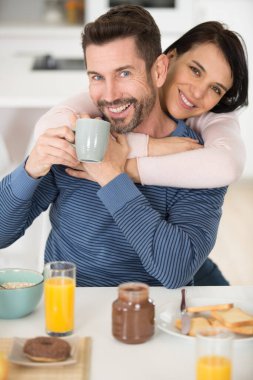 cute young couple flirting during breakfast time clipart