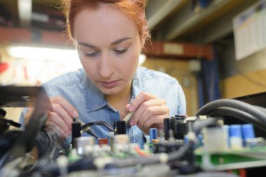 a female tech testing motherboard clipart