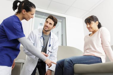 male doctor examining a patient in a room clipart