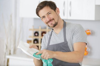 young man washing up dishes clipart