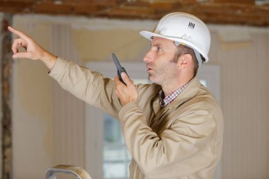 industrial worker talking on walkie-talkie clipart