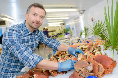 a portrait of a fishmonger selling crabs clipart