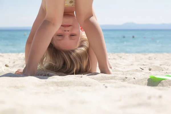 Happy Little Girl Standing Upside Sandy Beach Healthy Lifestyles Concept — стоковое фото