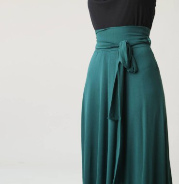 Serie of studio photos of young female model in comfortable yet stylish cotton outfit, black shit and emerald green skirt.