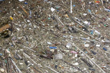 A giant floating rubbish heap floating in the river, plastic pollution, waste-clogged rivers. Huge environmental and health hazard. Problem of plastic that ends up in freshwater ecosystems.