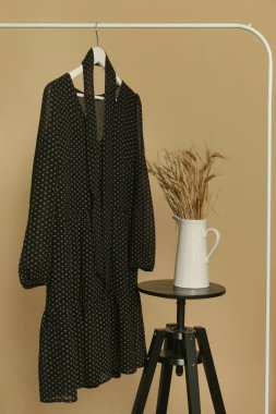 Women's Clothes. Clothes rack with boho style viscose dress on hanger. Good quality timeless fashion piece.