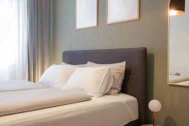 King size bed in simple and cozy bedroom.