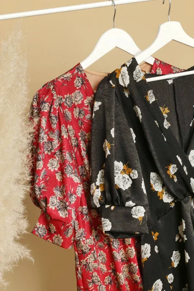 Women's Clothes. Clothes rack with stylish and elegant floral silk dresses in fashion atelier. Good quality timeless fashion pieces.
