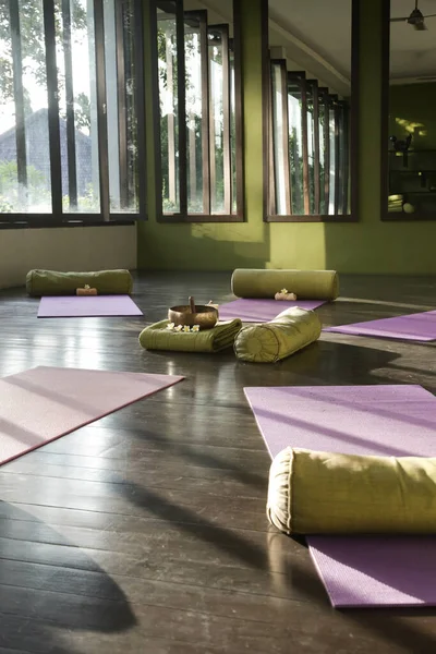 Blissful meditation studios to stop and feel zen. Empty yoga studio, mats, pillows and accessories, spacious meditation room