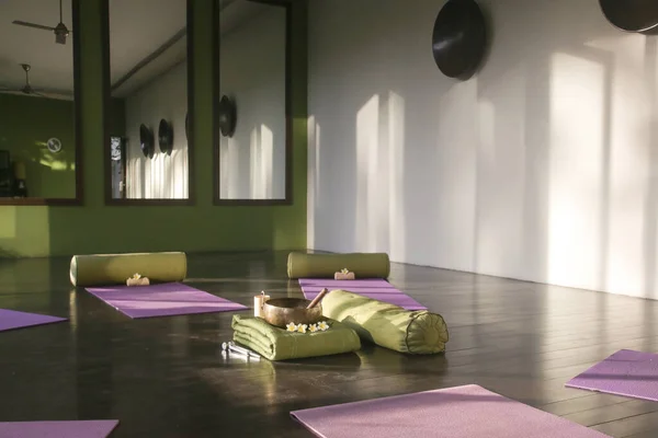Blissful meditation studios to stop and feel zen. Empty yoga studio, mats, pillows and accessories, spacious meditation room