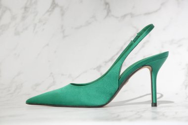 Creative studio shot of green satin slingbacks heels with the classy pointed toe, product photography clipart