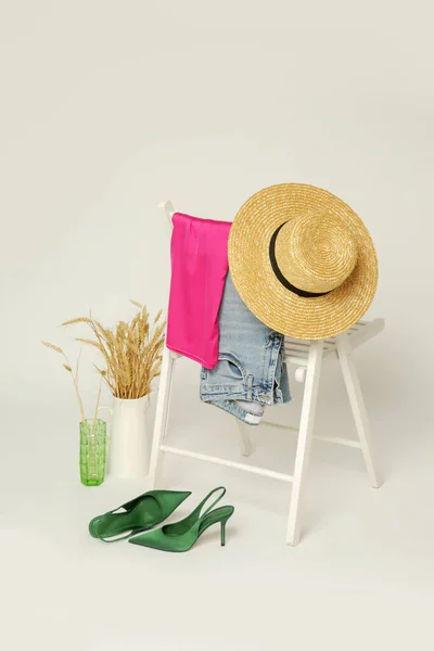 Clothes on a chair. Product photography, fashion still life. Spring summer outfits.