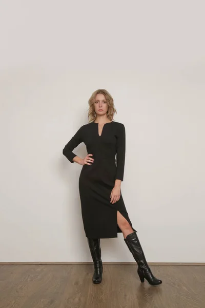 stock image Serie of studio photos of young female model in midi elastic black classic dress with long sleeves