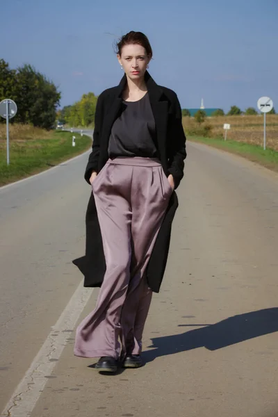 Woman Walking Middle Country Road Wearing Trousers Long Black Coat — Stock Photo, Image
