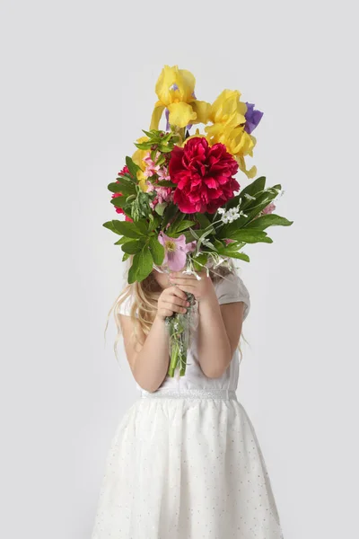 stock image Studio portrait of beautiful little girl holding big colorful bouquet of various flowers.