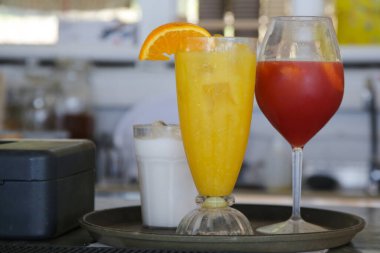 Bir bardak aperol spreyi ve bar tezgahında taze sıkılmış portakal suyu, ferahlatıcı yaz içecekleri.