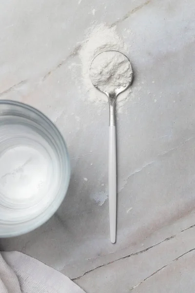 White powder in the spoon. Collagen protein powder or wheat flour. Concept of nutritional supplement, dieting, detox, preventive healthcare and healthy lifestyle.