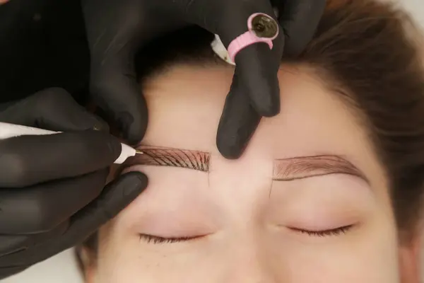 Microblading - semi-permanent tattooing technique used for the eyebrows by creating an illusion of a more defined and fuller brow. Artist makes tiny hair-like strokes to create a natural looking brows