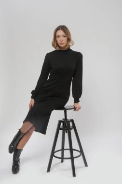 Stüdyo fotoğrafları, örgü siyah Midi elbisesi giymiş kadın model, sonbahar kış moda koleksiyonu.