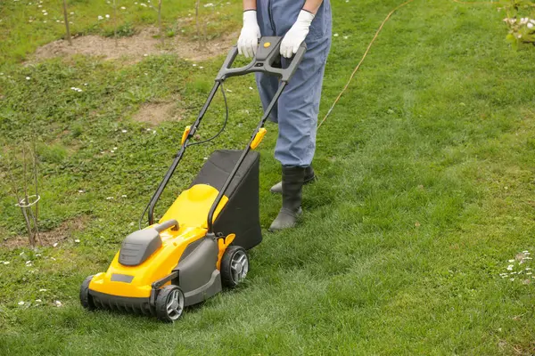 Gardener Black Rubber Boots Trimming Lawn Mower Royalty Free Stock Photos