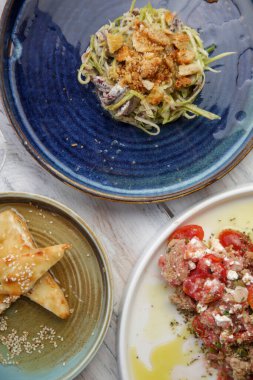 Various Mediterranean dishes served on the restaurant table