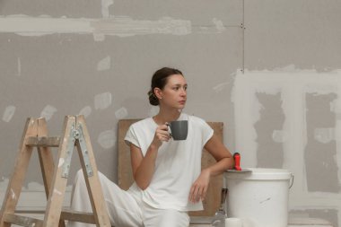 Bir Diy ev geliştirme projesinin ortasında bir mola genç bir kadının Portresi