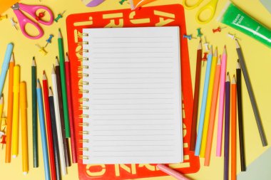 Sarı arka planda çeşitli ofis ve okul malzemeleriyle okul konseptine geri dönelim..