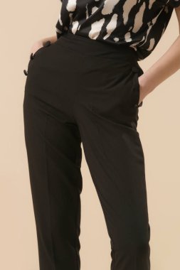 Female model wearing black smart casual business trousers. Studio shot. clipart