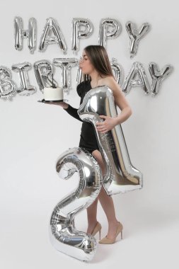 Doğum günü stüdyosu fotoshoot. Beyaz arka planda helyum balonları olan beyaz kız fotoğraf çekimi. 