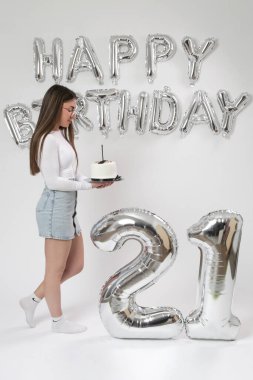 Doğum günü stüdyosu fotoshoot. Beyaz arka planda helyum balonları olan beyaz kız fotoğraf çekimi. 