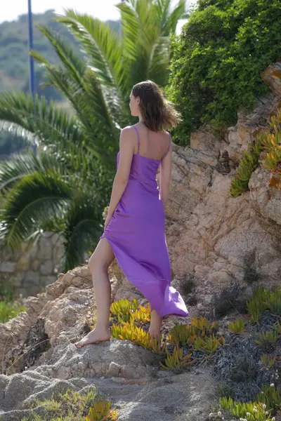 Gecelikli, pembe ipek, saten uzun elbiseler içinde güzel bir manken plaj stoklarında moda yaz portresi.