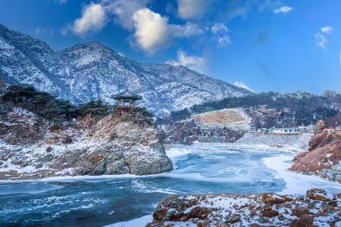 Korea Winter and mountains and frozen rivers on a clear day  in winter, South Korea. clipart