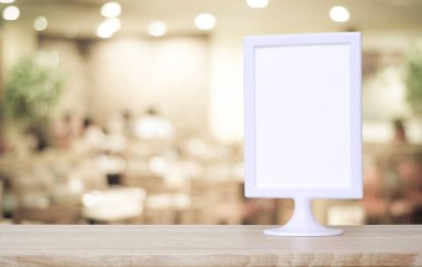 Boş beyaz menü tahtası bulanık restoranın üzerinde duruyor. Arka plan bokeh, metin için alan, maket, ürün ekran montajı, pankart