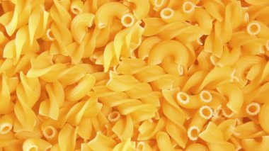 Pişmemiş Fusilli ve Chifferi Rigati Pasta - Top View. Şişman ve Sağlıksız Yemek. Klasik Kuru Makarna, Yavaşça Dönen Arkaplan. Raw Different Macaroni Makarna Dokusunu Sola Döndür