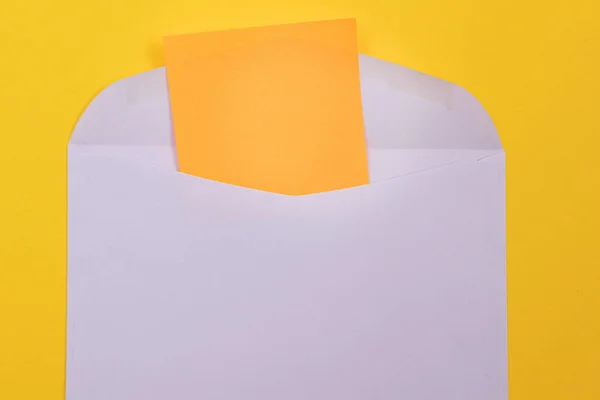 Violet Envelope Blank Orange Sheet Paper Lying Yellow Background Mock — стокове фото