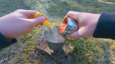Camp Food. Cooking in a Hike Using a Small Cook Set - First Person View, Wide Angle. Food on the Trip. Traveler in a Spring Forest. Tourist in a Travel is Heating Food - POV Shot.