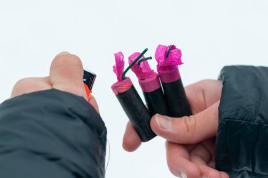 Adam kışın açık havada Flash Gürültülü Havai fişekleri ateşe veriyor. Gürültülü ve tehlikeli yeni yıl eğlencesi. Havai fişeklerle holiganlık. Halka Açık Yerlerdeki Petard 'ların Gürültüsü