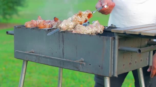 Man Cooking Pork Barbecue Summer Daytime Outdoors Static Shot Slow — Vídeos de Stock