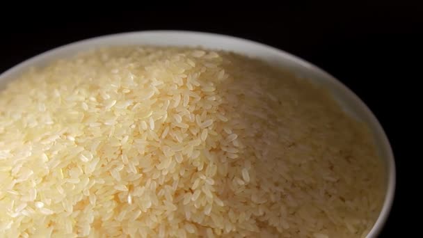 Dry Uncooked Parboiled Rice Heap Rotating Black Background Pile Raw — Vídeo de stock