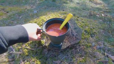 Camp Food. Cooking in a Hike Using a Small Cook Set - First Person View, Wide Angle. Food on the Trip. Traveler in a Spring Forest. Tourist in a Travel is Heating Food - POV Shot.