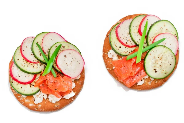 Crispy Cracker Sandwiches with Salmon, Cucumber, Radish, Cottage Cheese and Green Onions - Isolated on White. Easy Breakfast. Quick and Healthy Sandwiches. Crispbread with Tasty Filling - Isolation