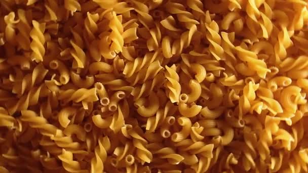 Uncooked Fusilli Chifferi Rigati Pasta Top View Low Key Light — стокове відео