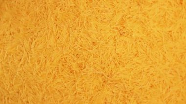 Background of Uncooked Golden Noodles that Rotating Clockwise - Top View. Texture of Dry Vermicelli Turning Around. Raw Pasta - Right Rotation