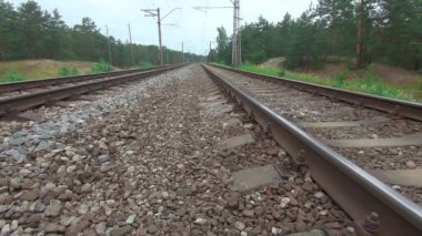 Çam Ormanı 'ndan geçen demiryolu boyunca geriye doğru hareket ediyor. Avrupa Elektrik Treni Treni - Gimbal Dengeleyicisinde Yumuşak Hareket