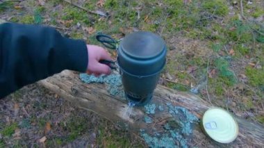 Camp Food. Cooking in a Hike Using a Small Cook Set - First Person View, Wide Angle. Food on the Trip. Traveler in a Spring Forest. Tourist in a Travel is Heating Food - POV Shot.