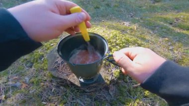 Camp Food. Cooking in a Hike Using a Small Cook Set - First Person View, Wide Angle. Food on the Trip. Traveler in a Spring Forest. Tourist in a Travel is Heating Food - POV Shot.