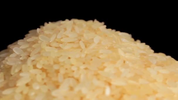 Dry Uncooked Parboiled Rice Heap Rotating Black Background Pile Raw — Vídeo de stock